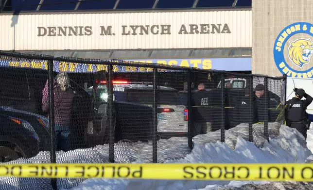 Police and ATF agents stand near the Lynch Arena in Pawtucket, R.I., after a shooting at the ice rink, Monday, Feb. 16, 2026. (AP Photo/Mark Stockwell)