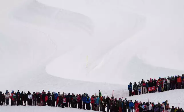 Spectators watch an alpine ski, men's slalom race, at the 2026 Winter Olympics, in Bormio, Italy, Monday, Feb. 16, 2026. (AP Photo/Julia Demaree Nikhinson)