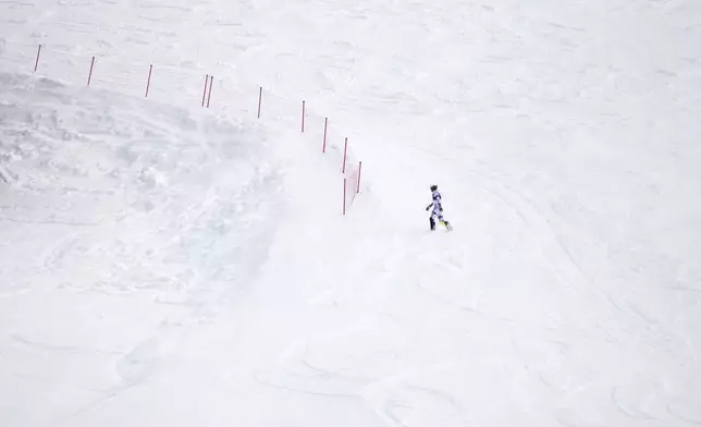 Norway's Atle Lie McGrath walks off the course after skiing out during an alpine ski, men's slalom race, at the 2026 Winter Olympics, in Bormio, Italy, Monday, Feb. 16, 2026. (AP Photo/John Locher)