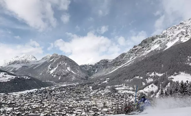 Chile's Tomas Holscher speeds down the course during an alpine ski, men's slalom race, at the 2026 Winter Olympics, in Bormio, Italy, Monday, Feb. 16, 2026. (AP Photo/Gabriele Facciotti)