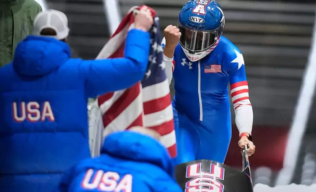 United States' gold medalist Elana Meyers Taylor celebrates at the finish after the women's monobob competition at the 2026 Winter Olympics, in Cortina d'Ampezzo, Italy, Monday, Feb. 16, 2026.(AP Photo/Aijaz Rahi)