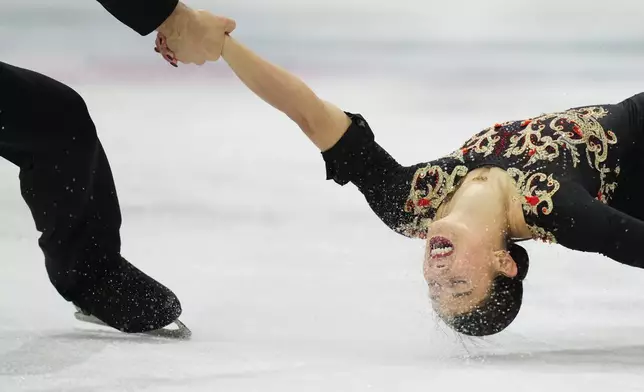 Rebecca Ghilardi and Filippo Ambrosini of Italy compete during the pairs figure skating long program at the 2026 Winter Olympics, in Milan, Italy, Monday, Feb. 16, 2026. (AP Photo/Francisco Seco)