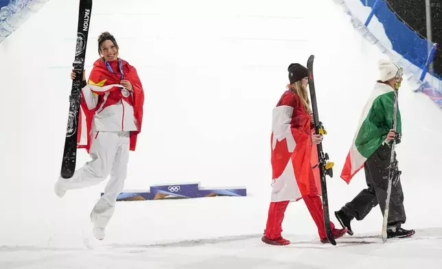 From left, silver medalist China's Eileen Gu celebrates as gold medalist Canada's Megan Oldham and bronze medalist Itay's Flora Tabanelli walk off after the women's freestyle skiing big air finals at the 2026 Winter Olympics, in Livigno, Italy, Monday, Feb. 16, 2026. (AP Photo/Lindsey Wasson)