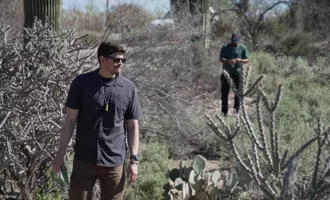 Law enforcement agents check vegetation areas around Nancy Guthrie’s home in Tucson, Ariz., Wednesday, Feb. 11, 2026. (AP Photo/Ty ONeil)