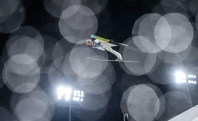 Kacper Tomasiak, of Poland, soars through the air during the ski jumping men's large hill individual at the 2026 Winter Olympics, in Predazzo, Italy, Saturday, Feb. 14, 2026. (AP Photo/Evgeniy Maloletka)