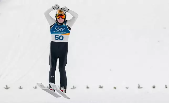 Domen Prevc, of Slovenia, celebrates after his final round jump during the ski jumping men's large hill individual at the 2026 Winter Olympics, in Predazzo, Italy, Saturday, Feb. 14, 2026. (AP Photo/Kirsty Wigglesworth)