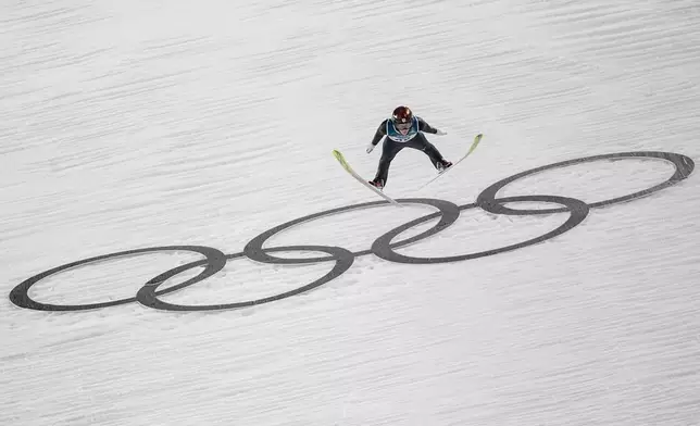 Ren Nikaido, of Japan, soars through the air during his first round jump of the ski jumping men's large hill individual at the 2026 Winter Olympics, in Predazzo, Italy, Saturday, Feb. 14, 2026. (AP Photo/Matthias Schrader)
