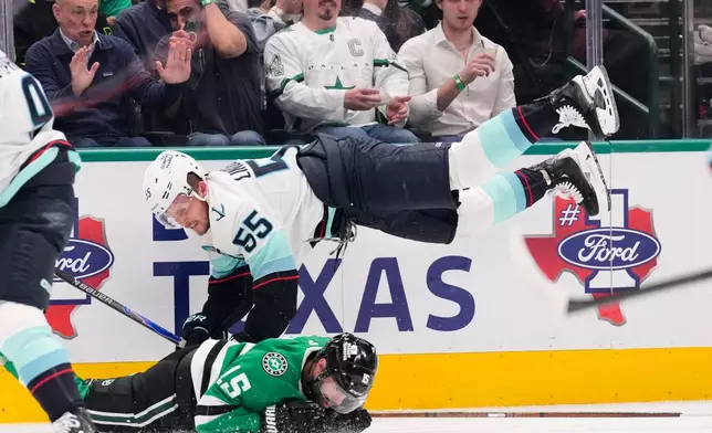 Seattle Kraken defenseman Ryan Lindgren (55) and Dallas Stars' Colin Blackwell (15) collide as they compete in the first period of an NHL hockey game in Dallas, Wednesday, Feb. 25, 2026. (AP Photo/Tony Gutierrez)