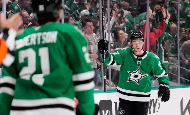 Dallas Stars' Wyatt Johnston (53) and Jason Robertson celebrate Johnston's goal in the first period of an NHL hockey game against the Seattle Kraken in Dallas, Wednesday, Feb. 25, 2026. (AP Photo/Tony Gutierrez)