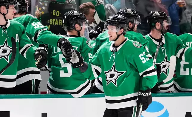 Dallas Stars center Wyatt Johnston (53) celebrates with teammates after scoring in the second period of an NHL hockey game against the Seattle Kraken in Dallas, Wednesday, Feb. 25, 2026. (AP Photo/Tony Gutierrez)