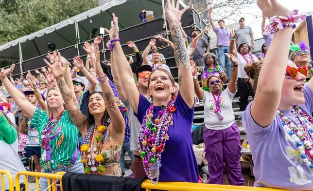Attendees march during the annual Krewe of Iris parade during the Mardi Gras season on Saturday, Feb. 14, 2026, in New Orleans. (Photo by Amy Harris/Invision/AP)