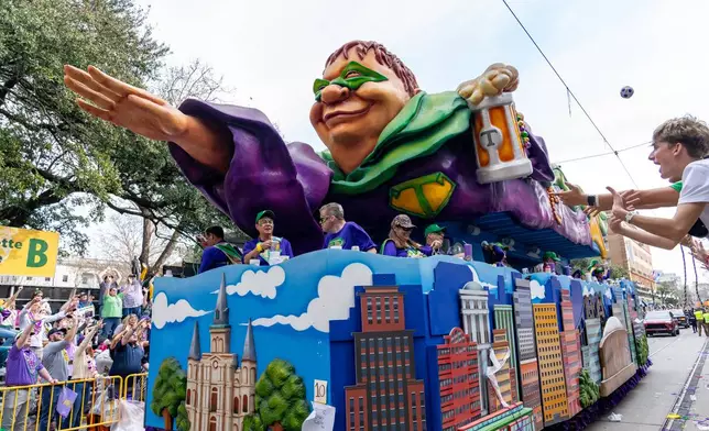Attendees march during the annual Krewe of Tucks parade during the Mardi Gras season on Saturday, Feb. 14, 2026, in New Orleans. (Photo by Amy Harris/Invision/AP)