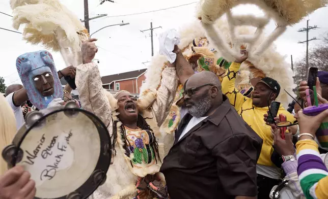 Black Masking Indians with the Black Feather including Big Chief Corey Rayford travel through the 7th Ward neighborhood on Mardi Gras Day, Tuesday, Feb. 17, 2026 in New Orleans. (AP Photo/Matthew Hinton)