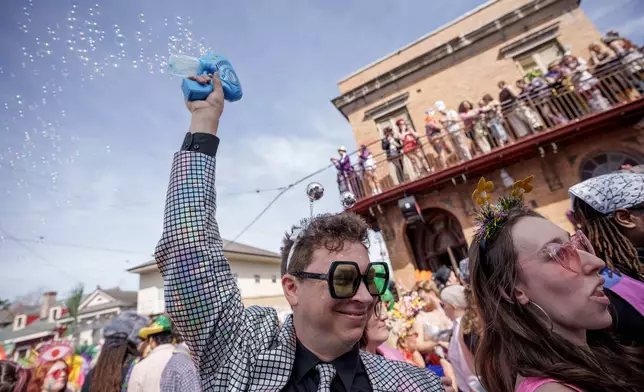People participating in the Society of Saint Anne parade wander through the Bywater and Marigny neighborhoods on Mardi Gras Day, Tuesday, Feb. 17, 2026 in New Orleans. (AP Photo/Matthew Hinton)