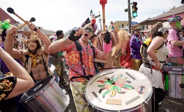 People participating in the Society of Saint Anne parade wander through the Bywater and Marigny neighborhoods on Mardi Gras Day, Tuesday, Feb. 17, 2026 in New Orleans. (AP Photo/Matthew Hinton)