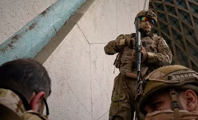 Members of Iran's Revolutionary Guard stand guard near the Azadi ( Freedom ) monument during the annual rally commemorating the 1979 Islamic Revolution at Azadi Square in Tehran, Iran, Wednesday, Feb. 11, 2026. (AP Photo/Vahid Salemi)