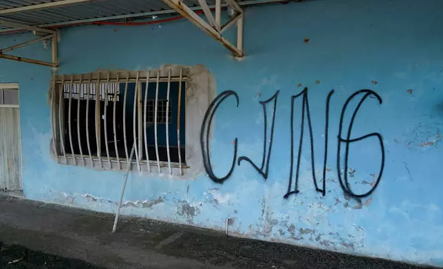 FILE - The letters "CJNG" for the group's formal name, Jalisco New Generation Cartel, covers the facade of an abandoned home in El Limoncito, in the Michoacan state of Mexico, Oct. 30, 2021. (AP Photo/Eduardo Verdugo, File)
