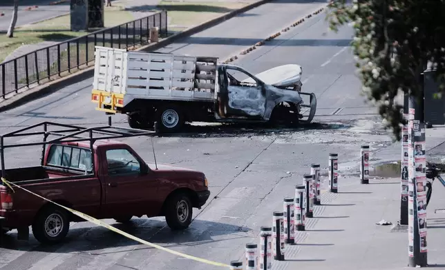A vehicle sits charred after being set on fire, on a road in Guadalajara, Jalisco state, Mexico, Sunday, Feb. 22, 2026, after the death of the leader of the Jalisco New Generation Cartel, "El Mencho." (AP Photo/Alejandra Leyva)