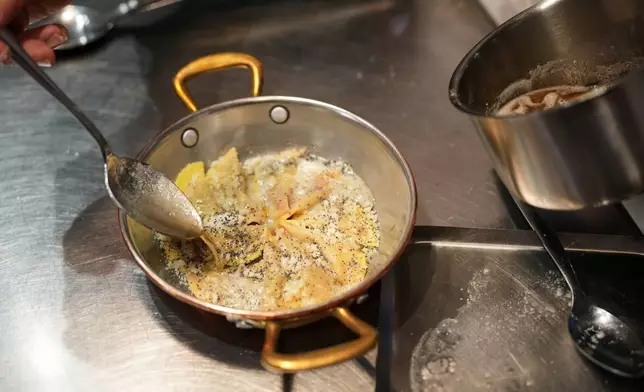 Local chef Gianluca Belli demonstrates how to make Casunziei, a type of ravioli that is Cortina's signature dish, during a pasta-making tutorial at a Michelin one-star restaurant in Cortina D'Ampezzo, Friday, Nov. 21, 2025. (AP Photo/Andrew Medichini)