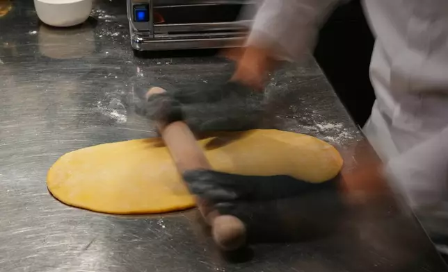 Local chef Gianluca Belli demonstrates how to make Casunziei, a type of ravioli that is Cortina's signature dish, during a pasta-making tutorial at a Michelin one-star restaurant in Cortina D'Ampezzo, Friday, Nov. 21, 2025. (AP Photo/Andrew Medichini)