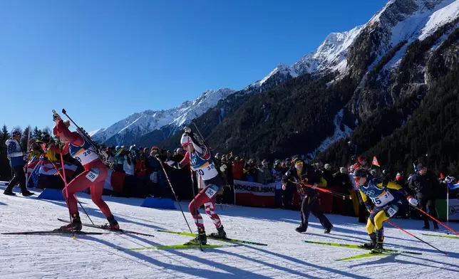 Amy Baserga, of Switzerland, from left, Lisa Theresa Hauser, of Austria, and Anna Magnusson, of Sweden, compete during the women's 10-kilometer pursuit biathlon race at the 2026 Winter Olympics in Anterselva, Italy, Sunday, Feb. 15, 2026. (AP Photo/Mosa'ab Elshamy)