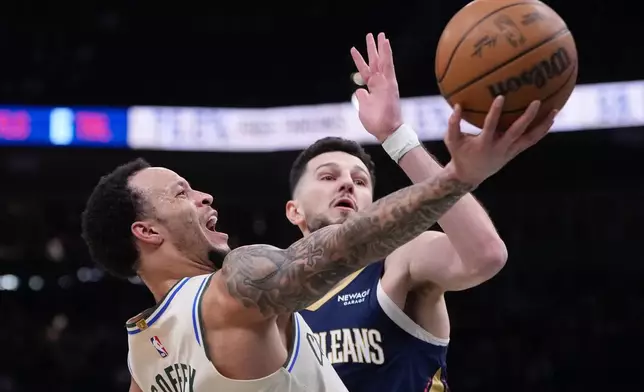 Milwaukee Bucks' Amir Coffey shoots past New Orleans Pelicans' Karlo Matkovic during the first half of an NBA basketball game Wednesday, Feb. 4, 2026, in Milwaukee. (AP Photo/Morry Gash)