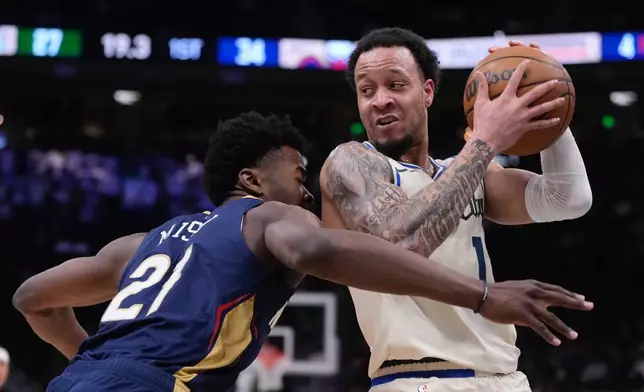 Milwaukee Bucks' Amir Coffey tries to get past New Orleans Pelicans' Yves Missi during the first half of an NBA basketball game Wednesday, Feb. 4, 2026, in Milwaukee. (AP Photo/Morry Gash)