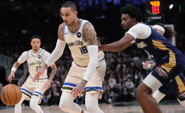 Milwaukee Bucks' Kyle Kuzma and New Orleans Pelicans' Herbert Jones go after a loose ball during the first half of an NBA basketball game Wednesday, Feb. 4, 2026, in Milwaukee. (AP Photo/Morry Gash)