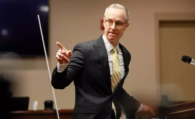 District Attorney Brad Smith points to the defendant Colin Gray, the father of Apalachee High School shooting suspect Colt Gray, during Smith's opening statements in the courtroom at the Barrow County courthouse, Monday, Feb. 16, 2026, in Winder, Ga. (Jason Getz/Atlanta Journal-Constitution via AP)