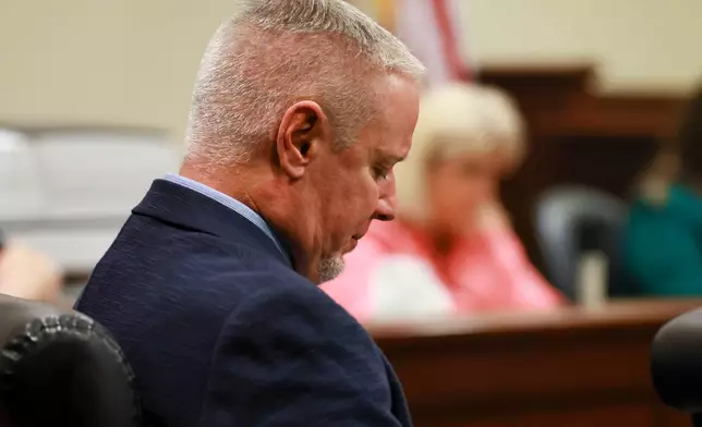 Colin Gray, the father of Apalachee High School shooting suspect Colt Gray, looks down as his attorney gives his opening statement in the courtroom at the Barrow County courthouse, Monday, Feb. 16, 2026, in Winder, Ga. (Jason Getz/Atlanta Journal-Constitution via AP)