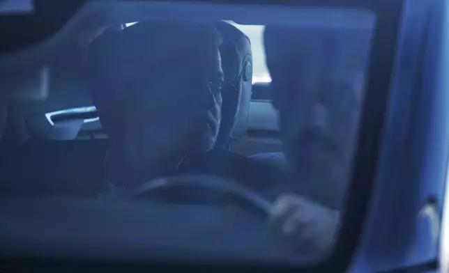 In this photo released by Iran's Supreme National Security Council office, Secretary of the Supreme National Security Council Ali Larijani sits in a car upon his arrival in Muscat, Oman, Tuesday, Feb. 10, 2026. (Erfan Kouchari/Iran's Supreme National Security Council Office via AP)