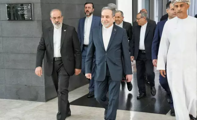 In this photo released by the Iranian Foreign Ministry, Iranian Foreign Minister Abbas Araghchi, center, heads to venue for talks between Iran and the U.S., in Muscat, Oman, Friday, Feb. 6, 2026. (Iranian Foreign Ministry via AP)