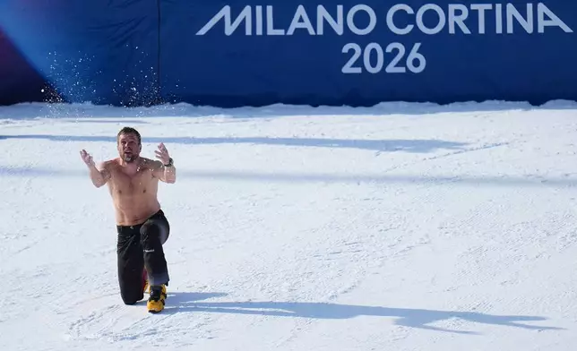 Austria's Benjamin Karl celebrates after winning the gold medal in men's snowboarding parallel giant slalom finals at the 2026 Winter Olympics, in Livigno, Italy, Sunday, Feb. 8, 2026. (AP Photo/Gregory Bull)