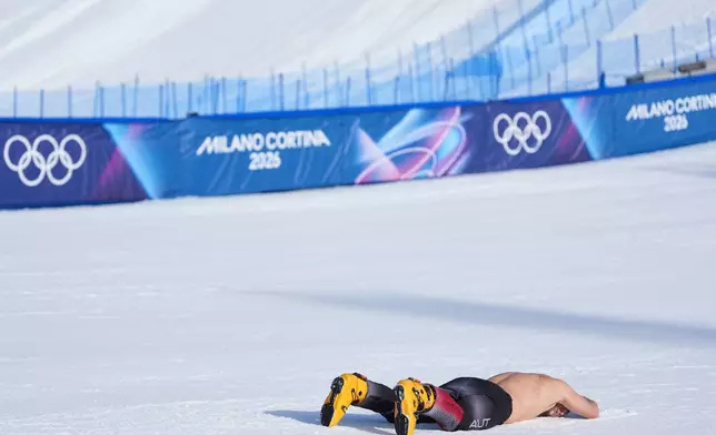 Austria's Benjamin Karl celebrates winning the gold medal in the men's snowboarding parallel giant slalom finals at the 2026 Winter Olympics, in Livigno, Italy, Sunday, Feb. 8, 2026. (AP Photo/Lindsey Wasson)
