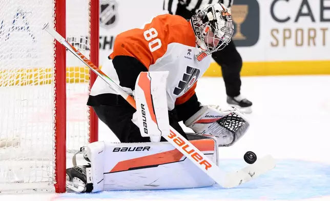 Philadelphia Flyers goaltender Dan Vladar stops the puck during the second period of an NHL hockey game against the Washington Capitals, Wednesday, Feb. 25, 2026, in Washington. (AP Photo/Nick Wass)
