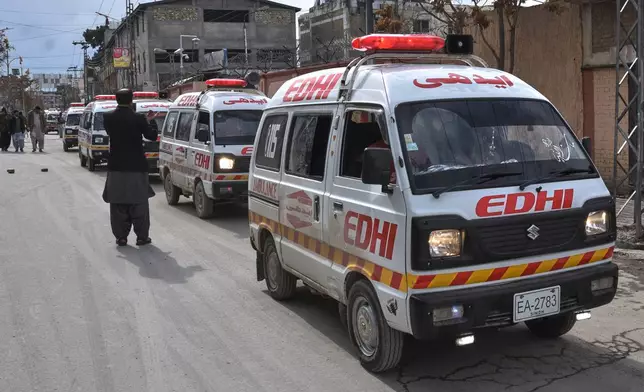 A journalist takes photo with his mobile phone to ambulances carrying the bodies of police officers who were killed in a militants attack, outside a hospital in Quetta, Pakistan, Saturday, Jan. 31, 2026. (AP Photo/Arshad Butt)