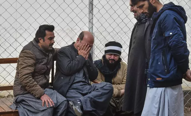 Relatives of police officers who were killed in a militants attack, mourn outside a hospital in Quetta, Pakistan, Saturday, Jan. 31, 2026. (AP Photo/Arshad Butt)