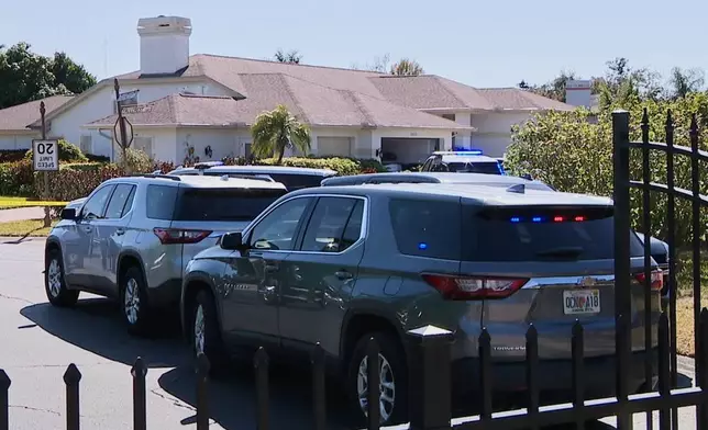 In this image taken from video provided by WFTS, law enforcement officers investigate a scene, Wednesday, Feb. 11, 2026, in Sarasota, Fla., which authorities say is connected to another crime scene, in Fort Lauderdale, Fla. (WFTS via AP)