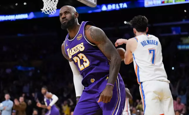 Los Angeles Lakers forward LeBron James (23) reacts after making a dunk during the first half of an NBA basketball game against the Oklahoma City Thunder Monday, Feb. 9, 2026, in Los Angeles. (AP Photo/Jae C. Hong)