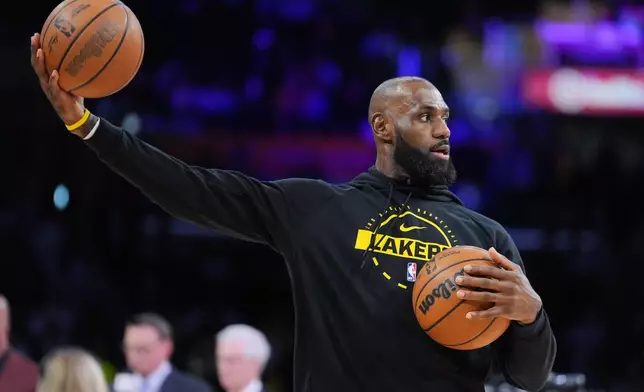 Los Angeles Lakers forward LeBron James warms up before the team's NBA basketball game against the Golden State Warriors Saturday, Feb. 7, 2026, in Los Angeles. (AP Photo/Jae C. Hong)