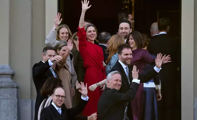Incumbent ministers wave to the media before being sworn in by King Willem-Alexander at Royal Palace Huis ten Bosch in The Hague, Netherlands, Monday, Feb. 23, 2026. (AP Photo/Peter Dejong)