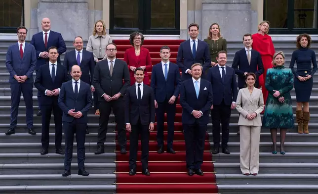 Ministers of the new three-party minority government pose with King Willem-Alexander, center right, prime minster Rob Jetten, center left, and deputy prime minister Dilan Yesilgöz, front row right, on the steps of Royal Palace Huis ten Bosch in The Hague, Netherlands, Monday, Feb. 23, 2026. (AP Photo/Peter Dejong)