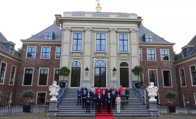 Ministers of the new three-party minority government pose with King Willem-Alexander, center right, prime minster Rob Jetten, center left, and deputy prime minister Dilan Yesilgöz, front row right, on the steps of Royal Palace Huis ten Bosch in The Hague, Netherlands, Monday, Feb. 23, 2026. (AP Photo/Peter Dejong)