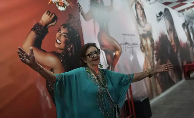 Former sex worker Lourdes Barreto dances during Porto da Pedra samba school's rehearsal for a parade, spotlighting sex workers to dismantle stigma, ahead of a Carnival parade in Sao Goncalo, Rio de Janeiro state, Brazil, Wednesday, Feb. 11, 2026. (AP Photo/Silvia Izquierdo)
