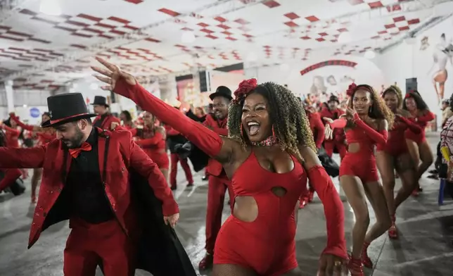 Members of Porto da Pedra samba school, which this year is raising awareness for sex workers to dismantle stigma, dance during a rehearsal ahead of the Carnival parade, in Sao Goncalo, Rio de Janeiro state, Thursday, Feb. 5, 2026. (AP Photo/Silvia Izquierdo)