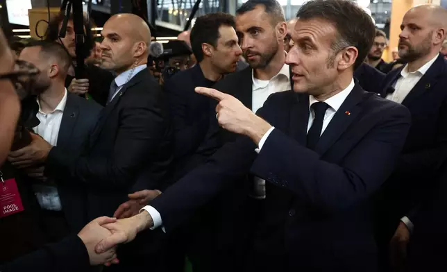 French President Emmanuel Macron attends the International Agriculture Fair during the opening day in Paris, Saturday, Feb. 21, 2026. (Christophe Petit Tesson/Pool Photo via AP)