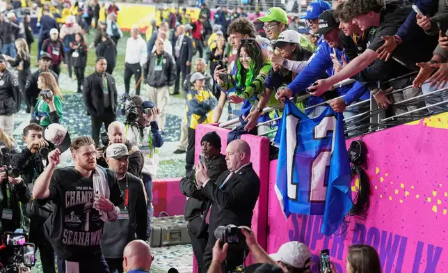 Seattle Seahawks quarterback Sam Darnold, left, celebrates as he walks off the field after winning the NFL Super Bowl 60 football game against the New England Patriots, Sunday, Feb. 8, 2026, in Santa Clara, Calif. (AP Photo/Godofredo A. Vásquez)