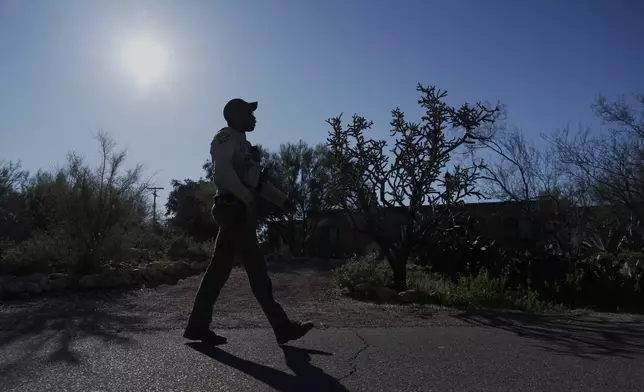A member of the Pima County sheriffs office remains outside of Nancy Guthrie's home, Monday, Feb. 9, 2026 in Tucson, Ariz. (AP Photo/Ty ONeil)