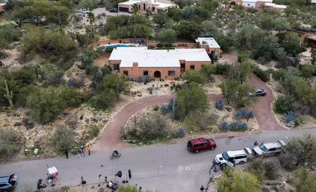 Members of the press work outside the home of Nancy Guthrie, the missing mother of “Today” show host Savannah Guthrie, Thursday, Feb. 5, 2026, in Tucson, Ariz. (AP Photo/Caitlin O'Hara)