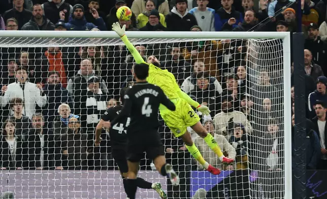Manchester City's goalkeeper Gianluigi Donnarumma, top, fails to stop a shot by Tottenham's Dominic Solanke to score the second goal during the English Premier League soccer match between Tottenham Hotspur and Manchester City in London, Sunday, Feb. 1, 2026. (AP Photo/Richard Pelham)